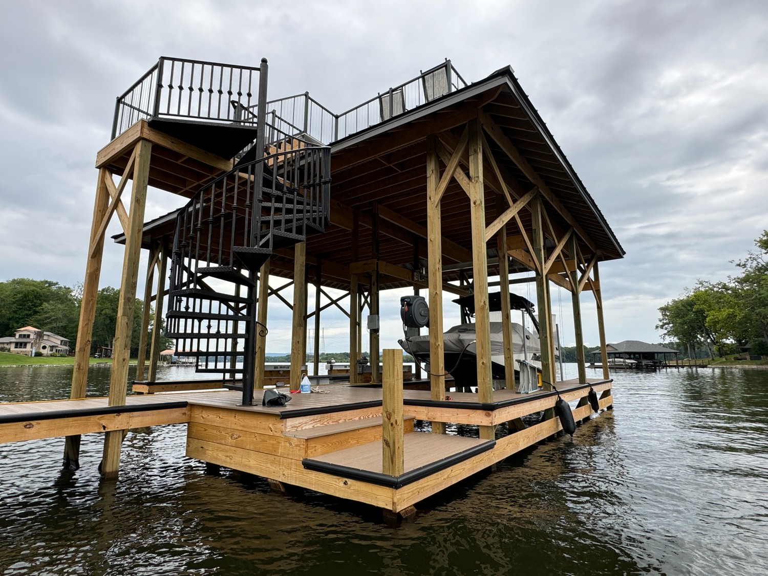 Two-story covered boat dock with spiral staircase on a Tennessee lake