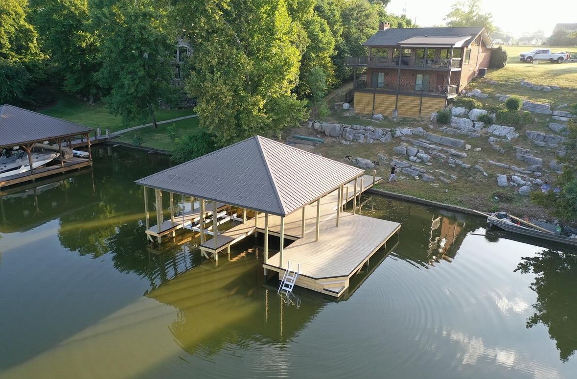 Aerial view of a covered boat dock on a Tennessee lake at golden hour