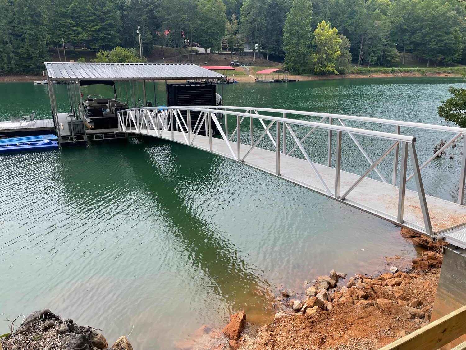 Aluminum gangway leading to a covered dock on a mountain lake