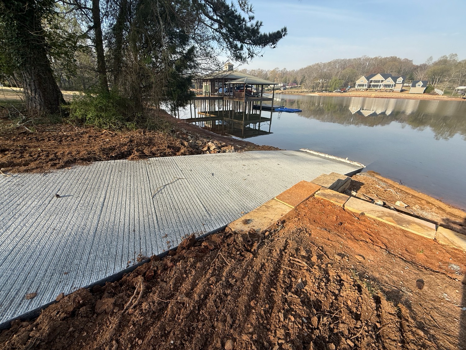 Newly poured concrete boat ramp at the water's edge